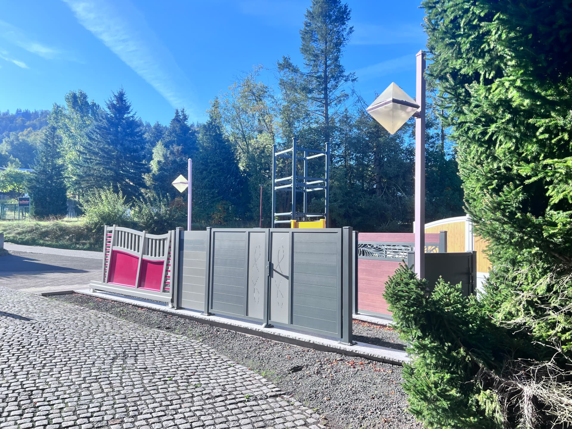 Außenbereich der Ausstellung mit Tor- und Zaunmustern von KAB Torsysteme